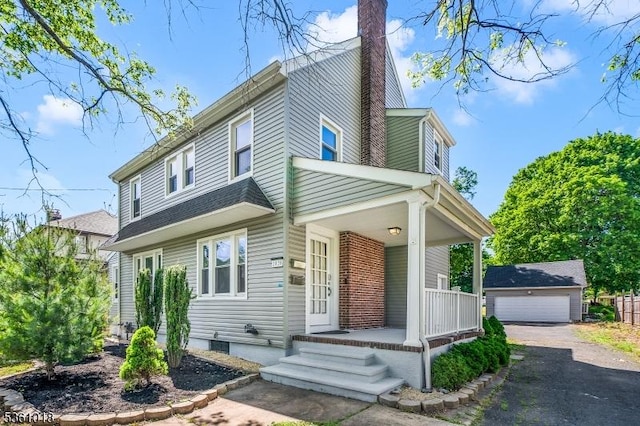 1038 Sherman Ave, Plainfield City, NJ 07063 - view of front facade featuring covered porch, a chimney, an outbuilding, and a garage