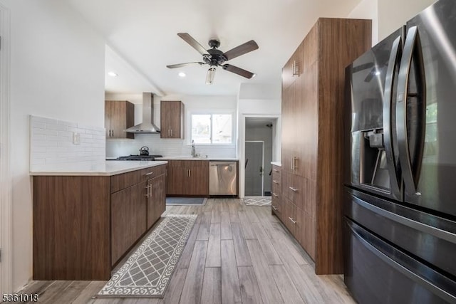 1038 Sherman Ave, Plainfield City, NJ 07063 - kitchen with appliances with stainless steel finishes, wall chimney range hood, light countertops, ceiling fan, and light wood finished floors