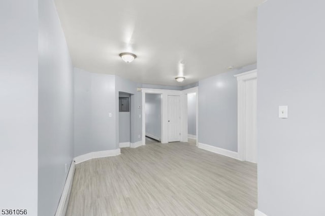 489 Conover Ter, City Of Orange Twp, NJ 07050 - spare room with a baseboard radiator, light wood-style floors, and baseboards