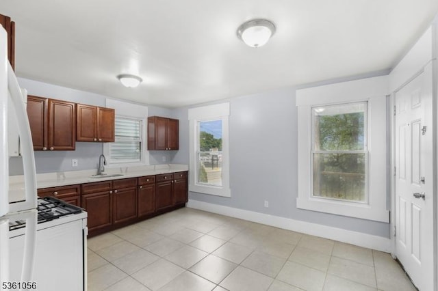 489 Conover Ter, City Of Orange Twp, NJ 07050 - kitchen featuring white appliances, a sink, light countertops, baseboards, and light tile patterned floors