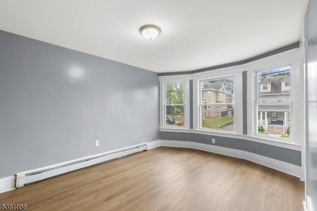 489 Conover Ter, City Of Orange Twp, NJ 07050 - spare room featuring a baseboard radiator, wood finished floors, and baseboards
