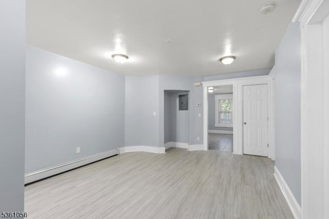 489 Conover Ter, City Of Orange Twp, NJ 07050 - empty room featuring a baseboard radiator, light wood-type flooring, baseboards, and a smoke detector