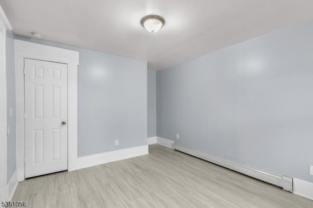 489 Conover Ter, City Of Orange Twp, NJ 07050 - empty room with a baseboard radiator, wood finished floors, baseboards, and a smoke detector