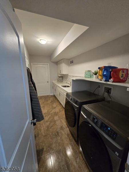 648 Marshall St, Elizabeth City, NJ 07206 - laundry room with independent washer and dryer and cabinet space