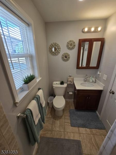 648 Marshall St, Elizabeth City, NJ 07206 - bathroom with vanity, toilet, baseboards, and tile patterned flooring
