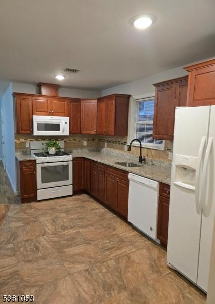 648 Marshall St, Elizabeth City, NJ 07206 - kitchen featuring white appliances, a sink, decorative backsplash, light stone countertops, and recessed lighting