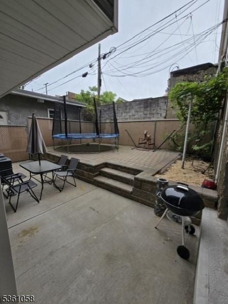 648 Marshall St, Elizabeth City, NJ 07206 - fenced backyard with a trampoline and a patio