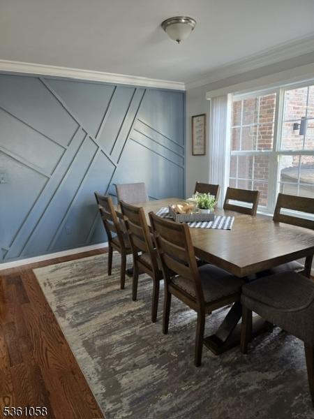 648 Marshall St, Elizabeth City, NJ 07206 - dining area with wood finished floors, ornamental molding, and a decorative wall