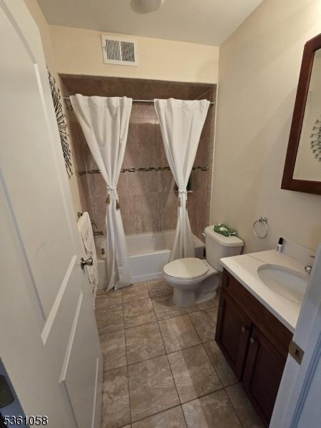 648 Marshall St, Elizabeth City, NJ 07206 - full bathroom with shower / bath combination with curtain, vanity, and toilet