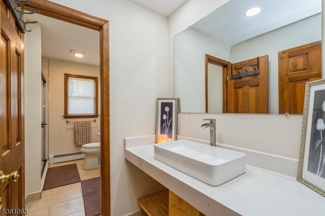 30 Claridge Ln, Raritan Twp, NJ 08822 - bathroom with a baseboard radiator, toilet, a stall shower, tile patterned floors, and vanity