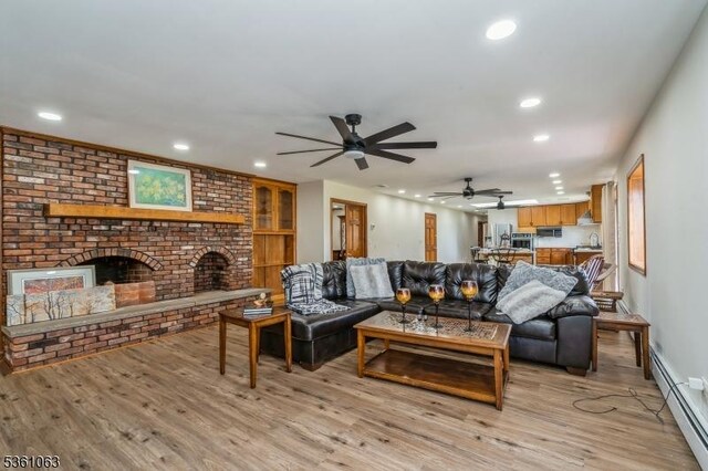 30 Claridge Ln, Raritan Twp, NJ 08822 - living area with a baseboard radiator, recessed lighting, light wood-style floors, ceiling fan, and a brick fireplace