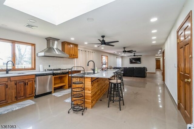 30 Claridge Ln, Raritan Twp, NJ 08822 - kitchen featuring appliances with stainless steel finishes, wall chimney range hood, recessed lighting, a sink, and a kitchen breakfast bar