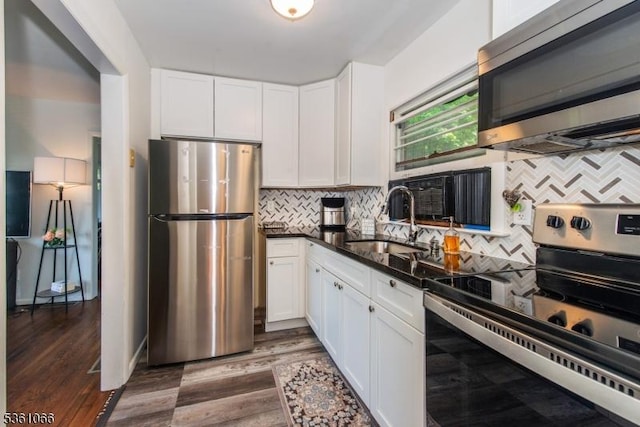 2 Shore Rd, Jefferson Twp, NJ 07849 - kitchen with stainless steel appliances, a sink, white cabinets, and decorative backsplash