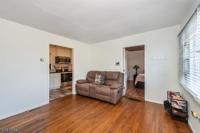 2 Shore Rd, Jefferson Twp, NJ 07849 - living room featuring dark wood-type flooring and baseboards