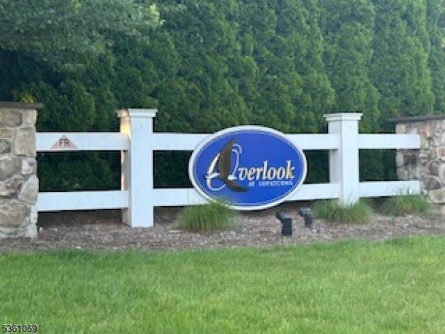 870 Honeybrook Cir, Lopatcong Twp, NJ 08886 - community / neighborhood sign featuring a wooded view and a lawn