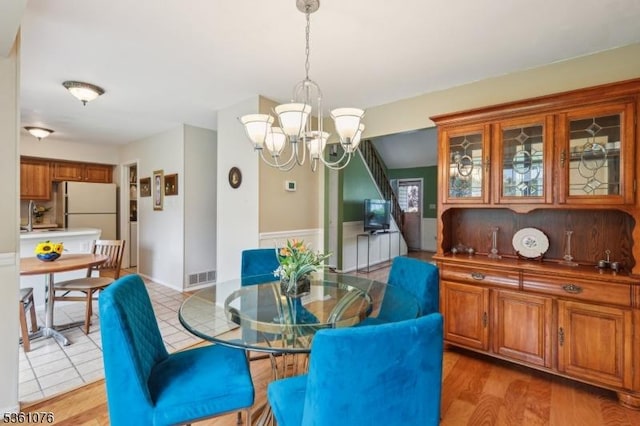 261 Bloomsbury Ct, Franklin Twp, NJ 08873 - dining area with a chandelier and wainscoting