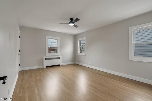 1535 Leslie St, Hillside Twp, NJ 07205 - spare room with radiator heating unit, ceiling fan, light wood-style flooring, and baseboards