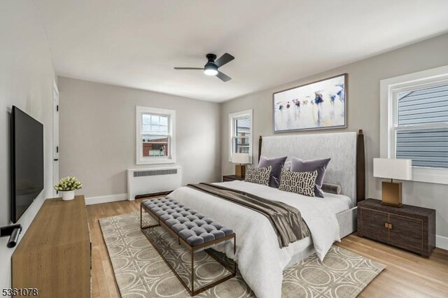 1535 Leslie St, Hillside Twp, NJ 07205 - bedroom with radiator, light wood-style flooring, baseboards, and ceiling fan