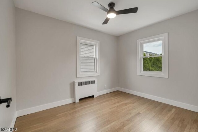 1535 Leslie St, Hillside Twp, NJ 07205 - unfurnished room with radiator heating unit, baseboards, light wood finished floors, and a ceiling fan