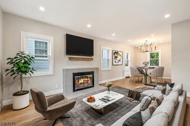 1535 Leslie St, Hillside Twp, NJ 07205 - living area with radiator heating unit, wood finished floors, a tile fireplace, a chandelier, and recessed lighting