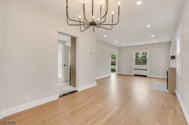 1535 Leslie St, Hillside Twp, NJ 07205 - unfurnished living room with radiator, a chandelier, light wood finished floors, recessed lighting, and baseboards
