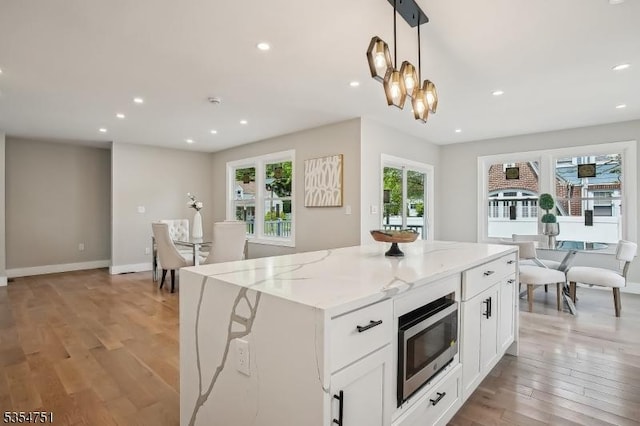 223 Victor St, Scotch Plains Twp, NJ 07076 - kitchen featuring stainless steel microwave, recessed lighting, light stone counters, white cabinetry, and light wood-type flooring