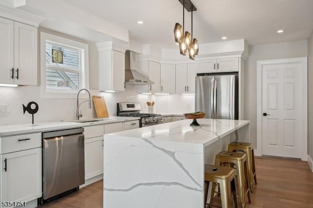 223 Victor St, Scotch Plains Twp, NJ 07076 - kitchen featuring appliances with stainless steel finishes, wall chimney exhaust hood, a sink, a kitchen island, and white cabinets