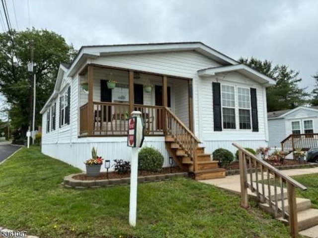 512 Kenbury Rd, Branchburg Twp, NJ 08876 - manufactured / mobile home with a porch, a front lawn, and stairs