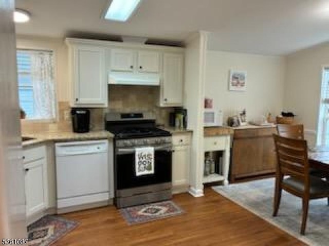 512 Kenbury Rd, Branchburg Twp, NJ 08876 - kitchen with white appliances, under cabinet range hood, white cabinets, and backsplash