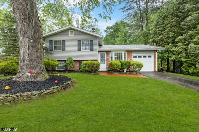 62 Valley View Rd, High Bridge Boro, NJ 08829 - tri-level home featuring an attached garage, asphalt driveway, a front yard, and brick siding