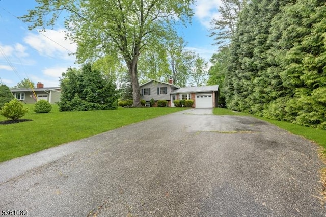 62 Valley View Rd, High Bridge Boro, NJ 08829 - tri-level home featuring driveway, a garage, and a front yard