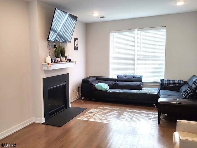 92 Sowers Dr Unit Cu92, Mount Olive Twp, NJ 07840 - living area featuring healthy amount of natural light, wood finished floors, and a fireplace with raised hearth