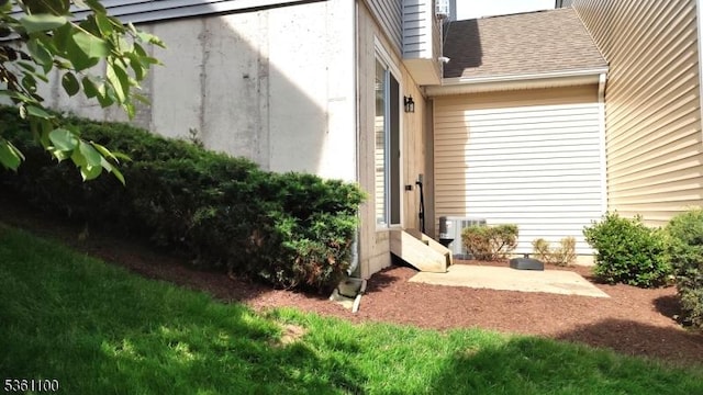 92 Sowers Dr Unit Cu92, Mount Olive Twp, NJ 07840 - view of exterior entry with cooling unit and a shingled roof