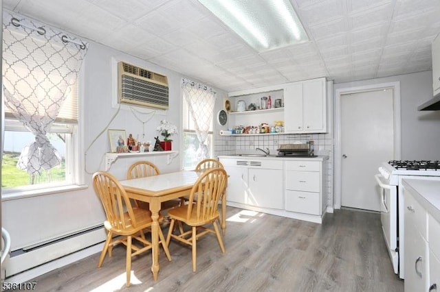 328 Hoover Ave, Bloomfield Twp, NJ 07003 - kitchen featuring white range with gas cooktop, a baseboard heating unit, open shelves, wood finished floors, and white cabinets