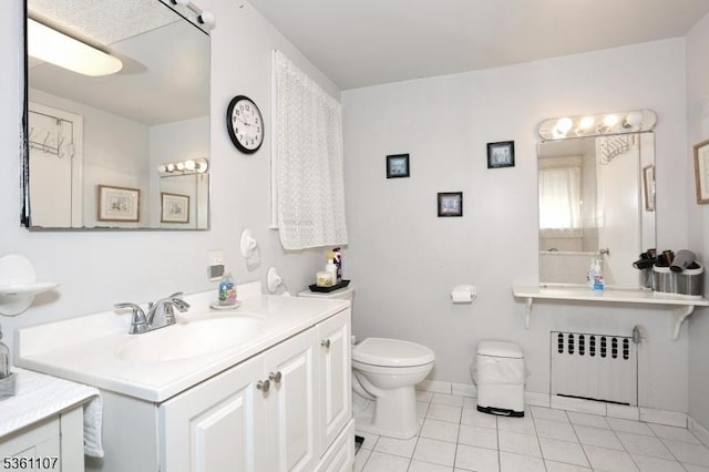 328 Hoover Ave, Bloomfield Twp, NJ 07003 - bathroom featuring radiator heating unit, tile patterned floors, toilet, vanity, and baseboards