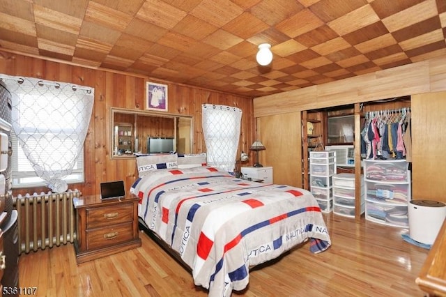 328 Hoover Ave, Bloomfield Twp, NJ 07003 - bedroom featuring radiator, wood walls, light wood-type flooring, and wooden ceiling