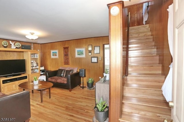 328 Hoover Ave, Bloomfield Twp, NJ 07003 - living area with stairs, light wood-style flooring, and wood walls