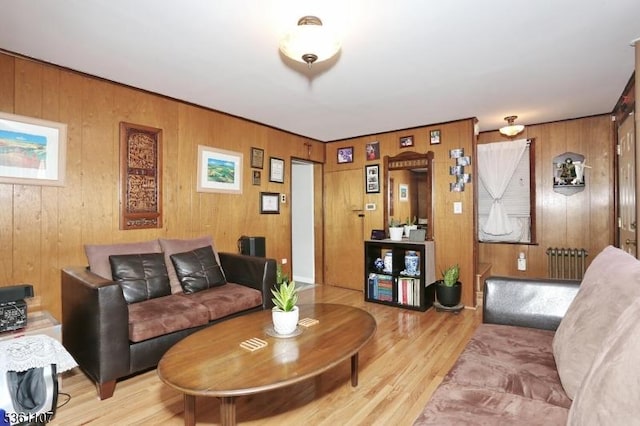 328 Hoover Ave, Bloomfield Twp, NJ 07003 - living room featuring radiator, light wood-style flooring, and wooden walls