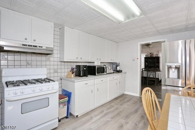 328 Hoover Ave, Bloomfield Twp, NJ 07003 - kitchen featuring appliances with stainless steel finishes, under cabinet range hood, light countertops, white cabinetry, and an ornate ceiling