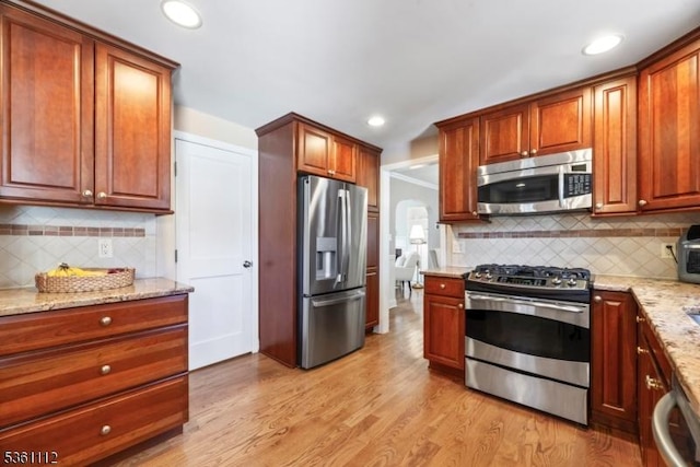 13 Henley Ave, Cranford Twp, NJ 07016 - kitchen with stainless steel appliances, decorative backsplash, light stone counters, light wood-style flooring, and recessed lighting
