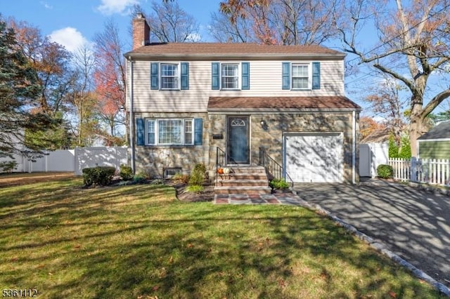 13 Henley Ave, Cranford Twp, NJ 07016 - view of front facade with a chimney, driveway, and a garage