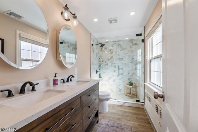 13 Henley Ave, Cranford Twp, NJ 07016 - bathroom featuring toilet, a marble finish shower, double vanity, radiator, and wood finished floors