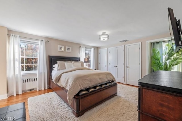 13 Henley Ave, Cranford Twp, NJ 07016 - bedroom featuring radiator, light wood-type flooring, and multiple closets