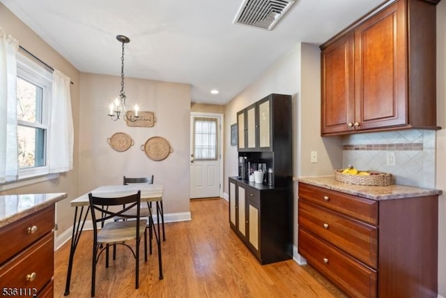 13 Henley Ave, Cranford Twp, NJ 07016 - kitchen with light wood finished floors, tasteful backsplash, light stone countertops, hanging light fixtures, and a chandelier