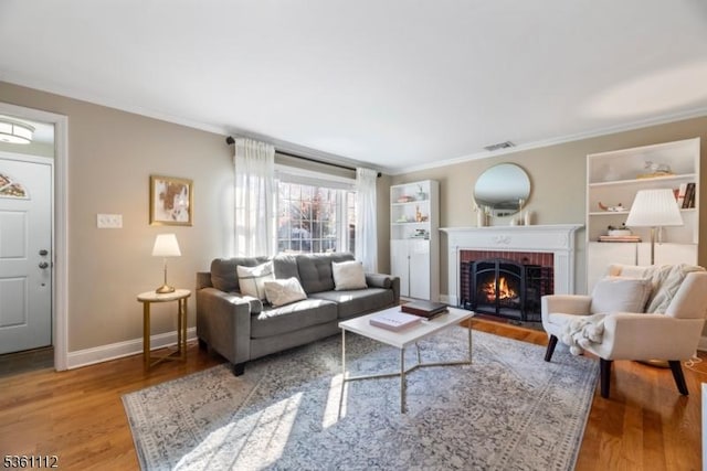 13 Henley Ave, Cranford Twp, NJ 07016 - living room with ornamental molding, wood finished floors, a brick fireplace, and baseboards