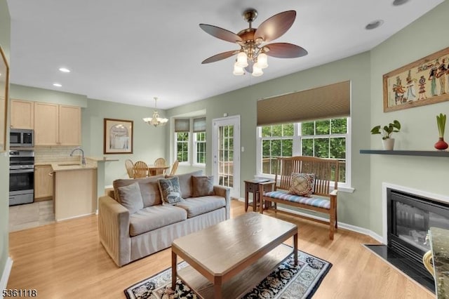 42 Rockcreek Ter Unit 42, Riverdale Boro, NJ 07457 - living area with a chandelier, light wood-type flooring, a ceiling fan, recessed lighting, and a fireplace with flush hearth