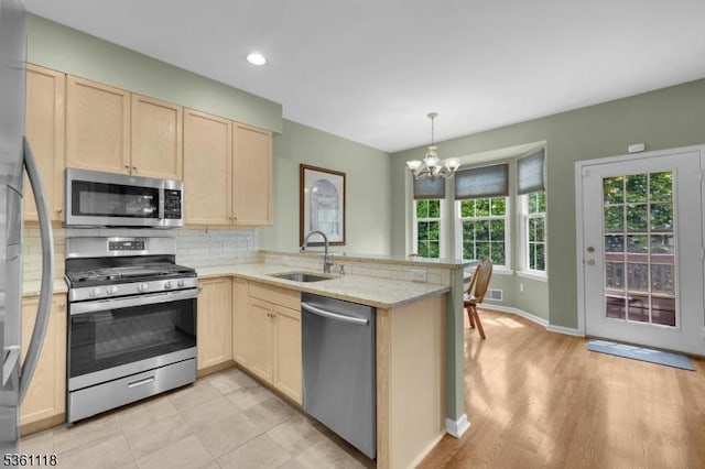 42 Rockcreek Ter Unit 42, Riverdale Boro, NJ 07457 - kitchen with stainless steel appliances, a sink, light brown cabinetry, a peninsula, and recessed lighting