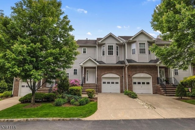 42 Rockcreek Ter Unit 42, Riverdale Boro, NJ 07457 - townhome / multi-family property featuring brick siding, driveway, and an attached garage