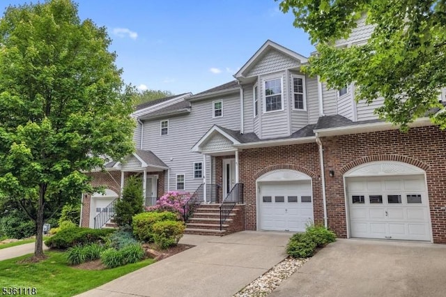 42 Rockcreek Ter Unit 42, Riverdale Boro, NJ 07457 - view of property featuring an attached garage, concrete driveway, and brick siding