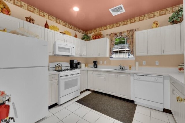 42 Rockcreek Ter Unit 42, Riverdale Boro, NJ 07457 - kitchen featuring white appliances, a sink, white cabinetry, light countertops, and light tile patterned floors